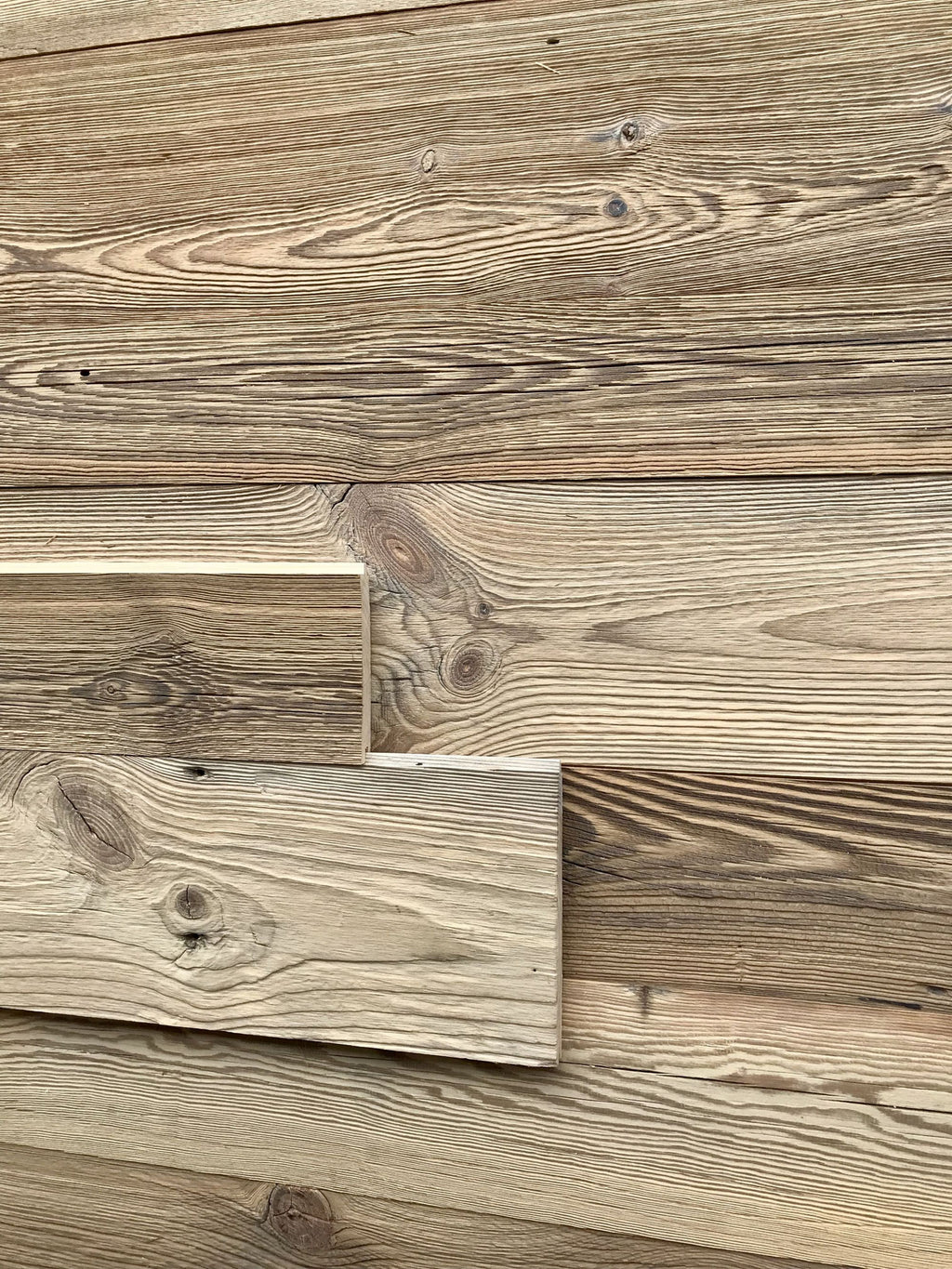 Reclaimed wood tongue and groove boards with naturally aged brown surface