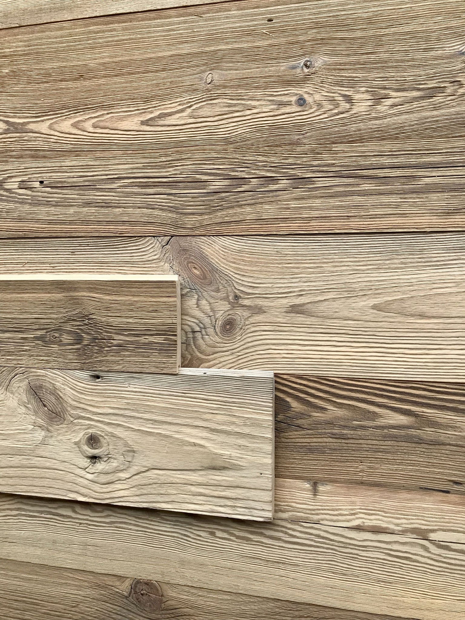 Reclaimed wood tongue and groove boards with naturally aged brown surface