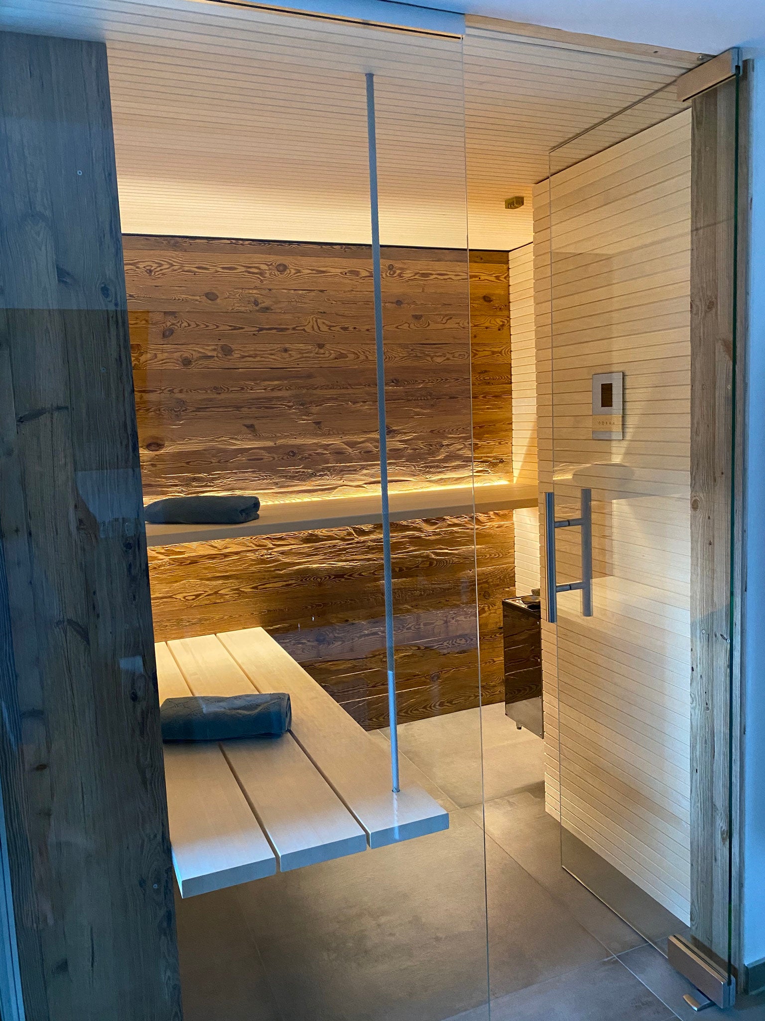 Hand-hewn reclaimed wood wall cladding in a rustic sauna interior