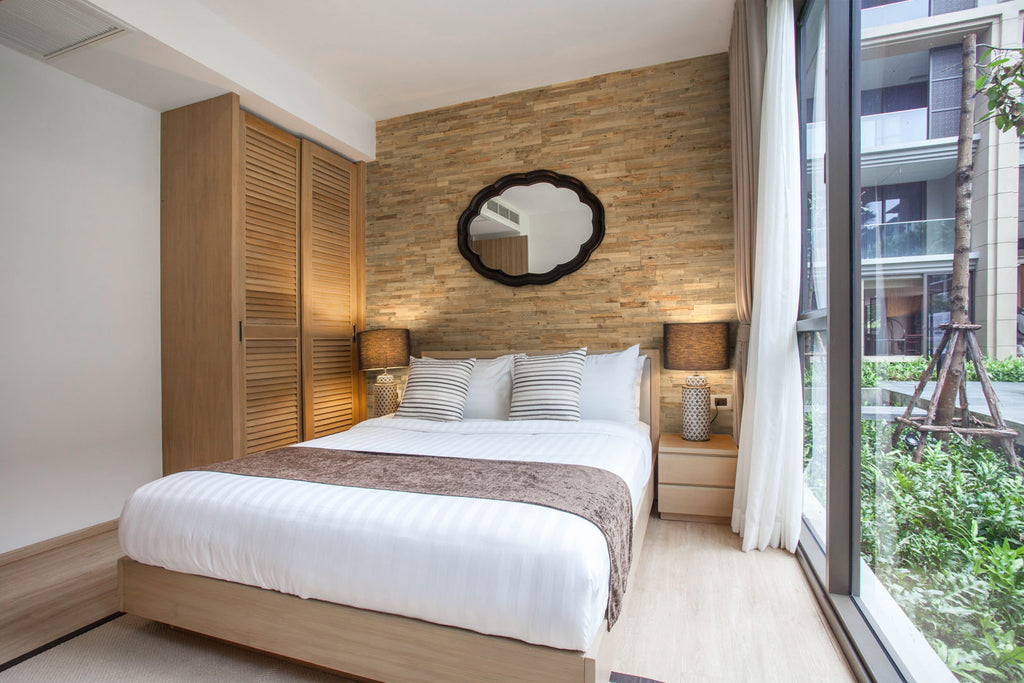 Reclaimed wood wall cladding in a bedroom with a modern feature wall
