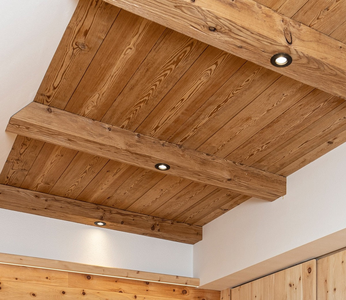 Steamed larch tongue and groove boards installed as ceiling cladding