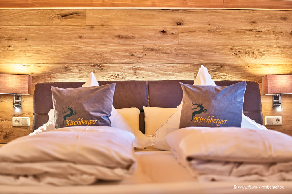 Hewn and brushed oak tongue and groove wall cladding in a bedroom