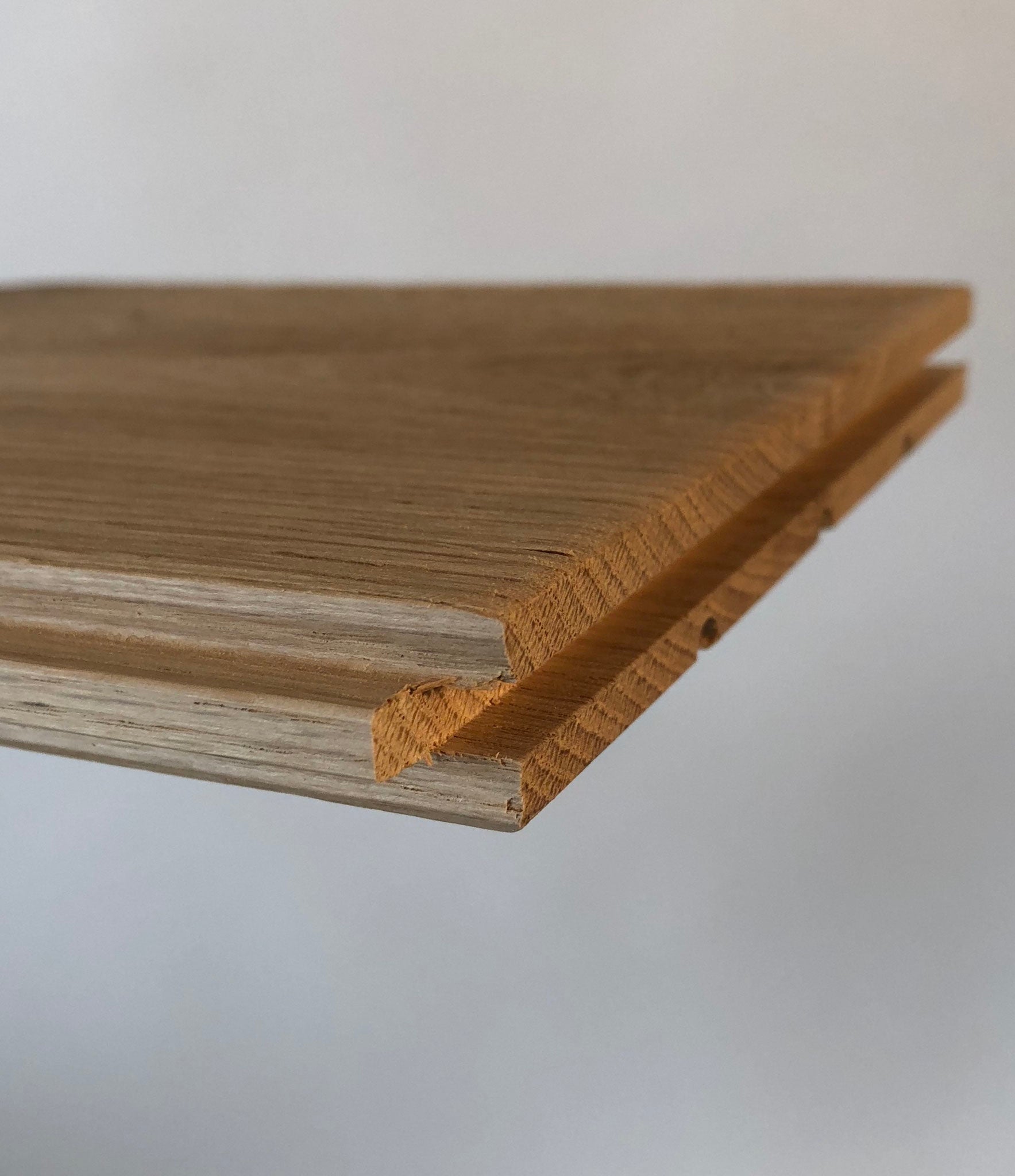 Close view of brushed oak tongue and groove wall cladding board