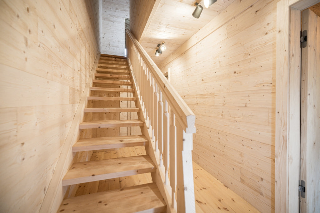 Hewn and brushed spruce wall cladding with natural rustic texture