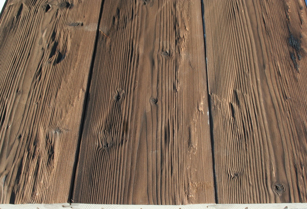 Rustic burnt spruce wall cladding with natural grain and texture