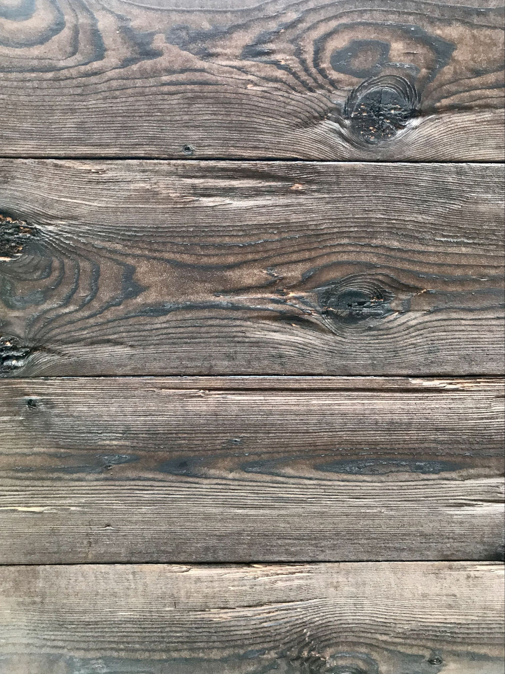 Burnt spruce tongue and groove board with hewn rustic texture