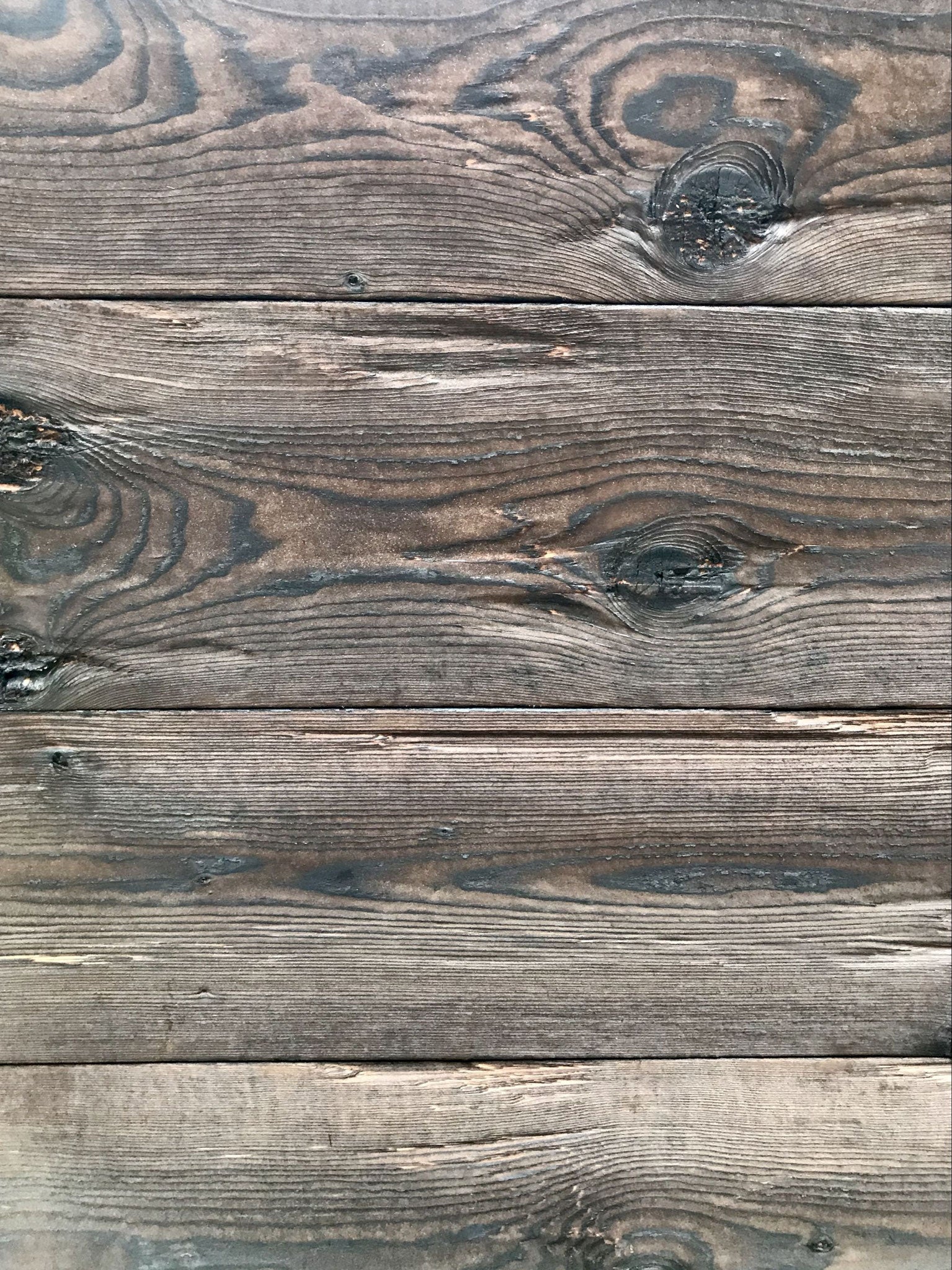 Burnt spruce tongue and groove board with hewn rustic texture