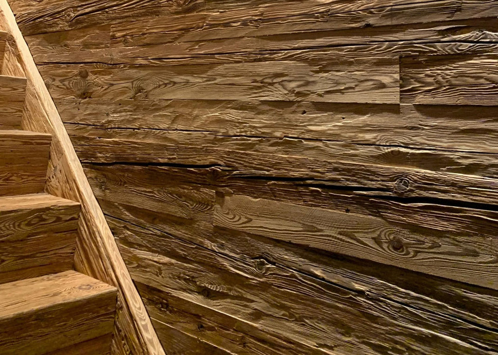 Feature wall with hand-hewn reclaimed wood boards by Vintage Holz
