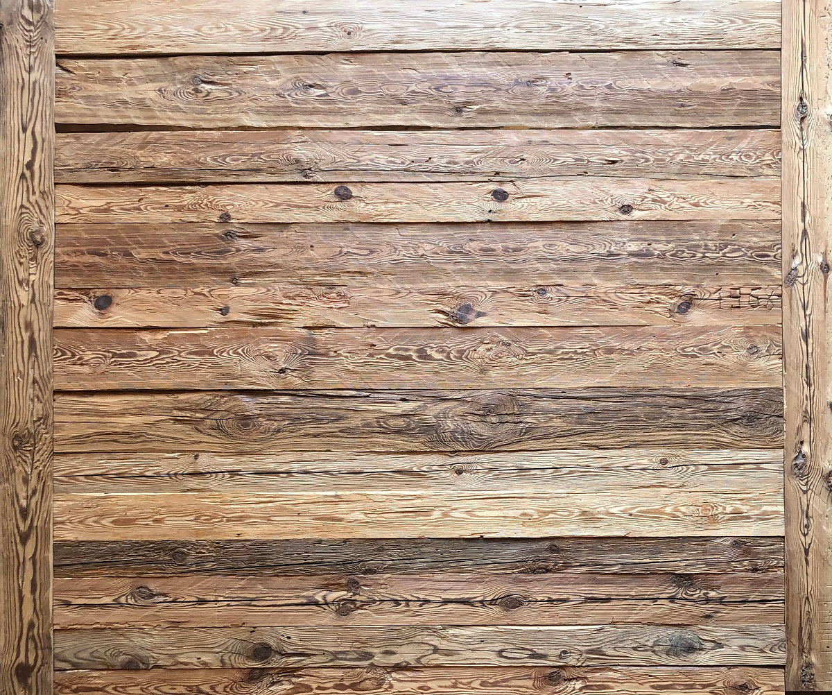 Hand-hewn reclaimed wood boards used as rustic wall cladding