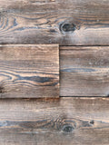 Burnt spruce tongue and groove wall cladding with rustic hewn surface