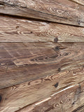 Hand-hewn reclaimed wood boards with authentic axe marks and rustic surface