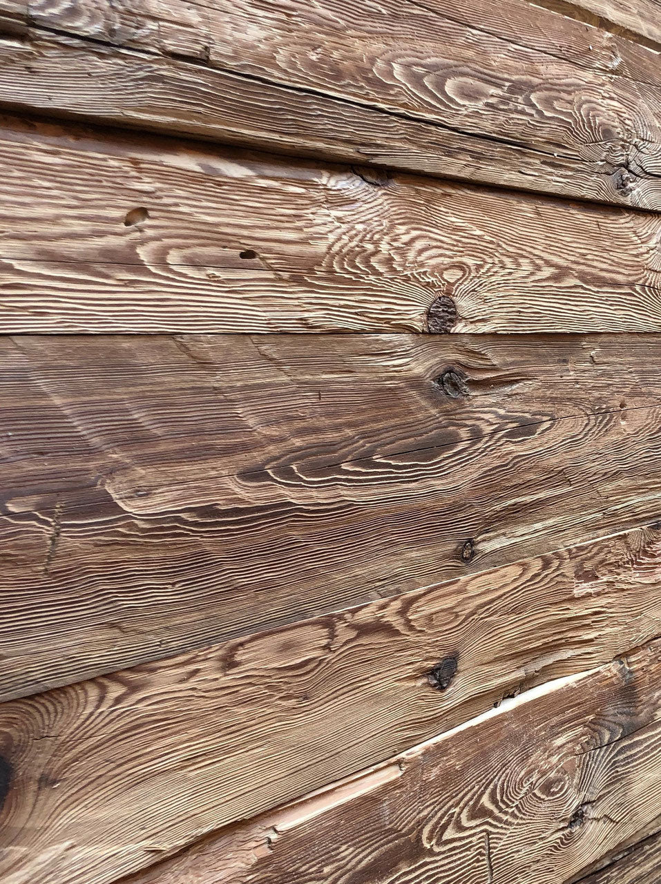 Hand-hewn reclaimed wood boards with authentic axe marks and rustic surface
