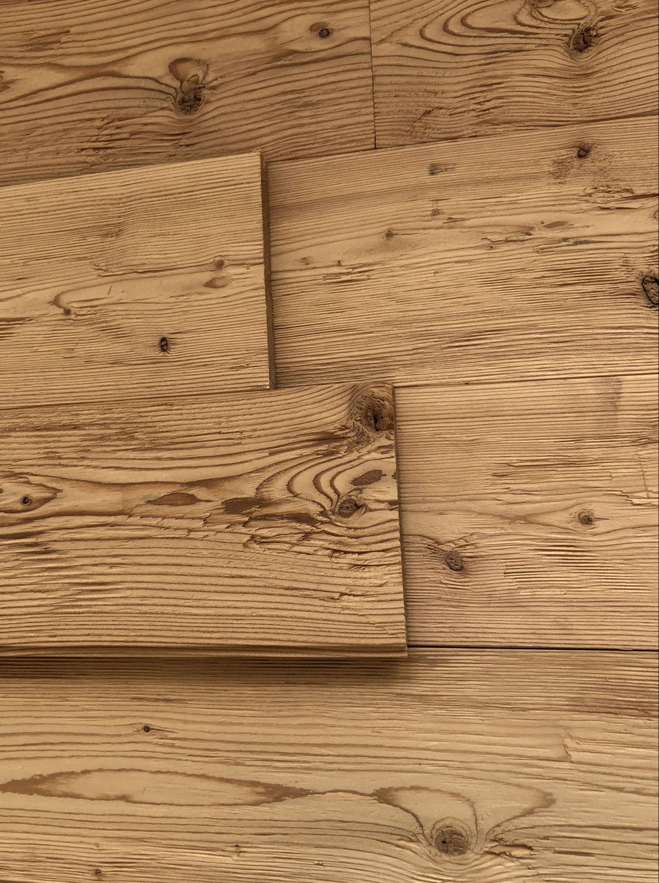Steamed larch tongue and groove wall cladding with hewn and brushed surface