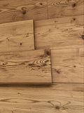 Steamed larch tongue and groove wall cladding with hewn and brushed surface