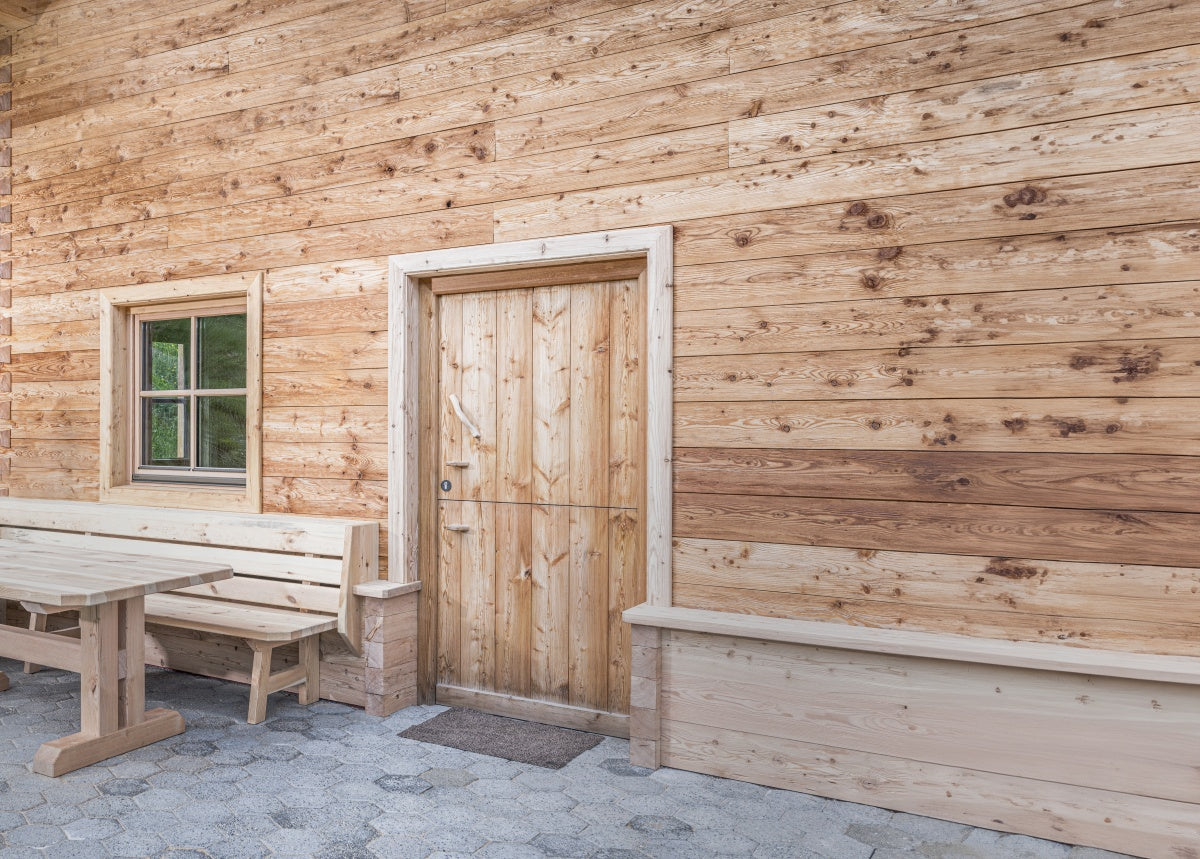 Hewn and brushed larch tongue and groove boards used as facade cladding