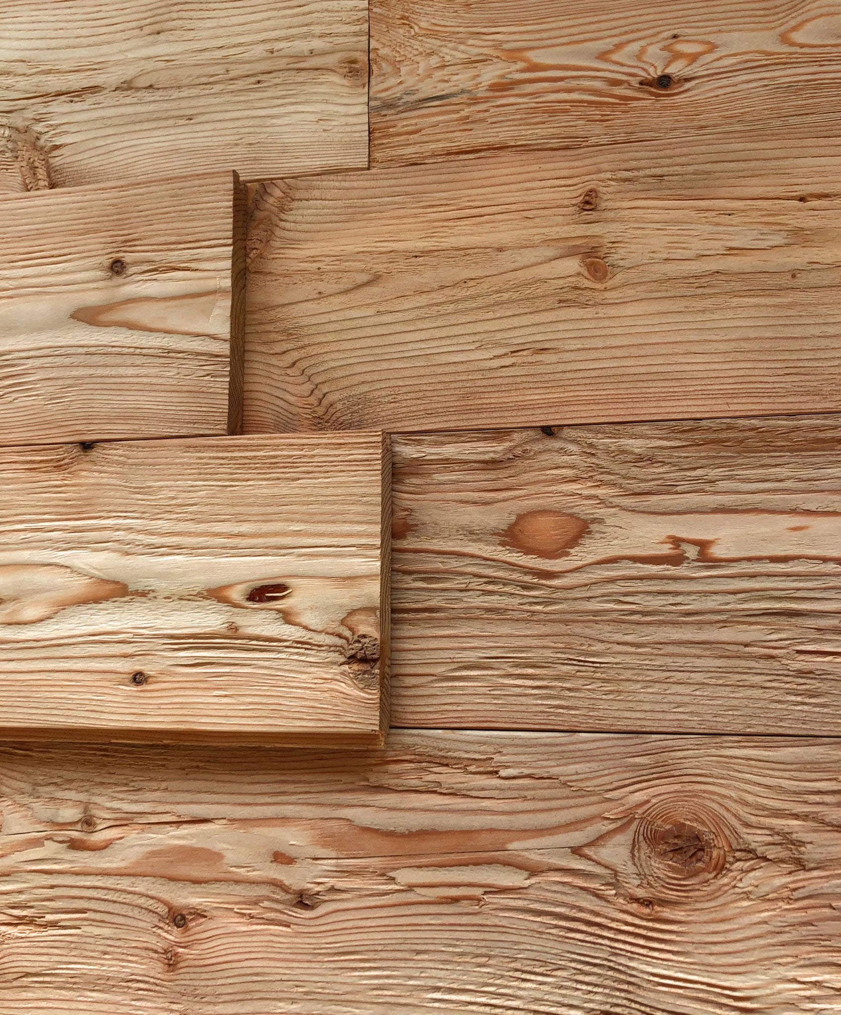 Hewn and brushed larch wood for wall and ceiling cladding