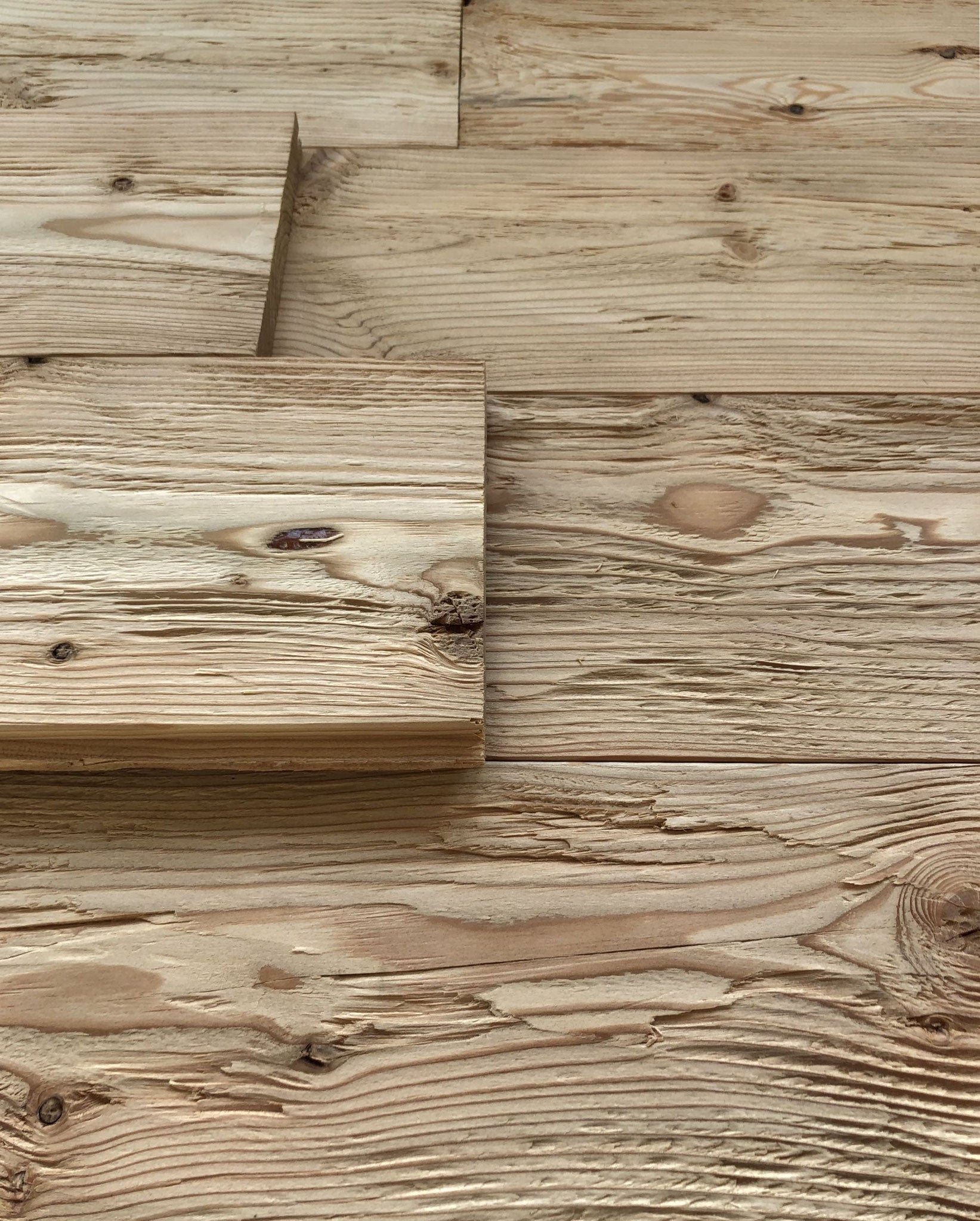 Hewn and brushed larch wall cladding with tongue and groove profile