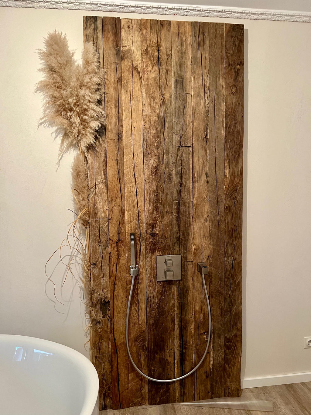 Interior wall finished with hand-hewn reclaimed oak boards