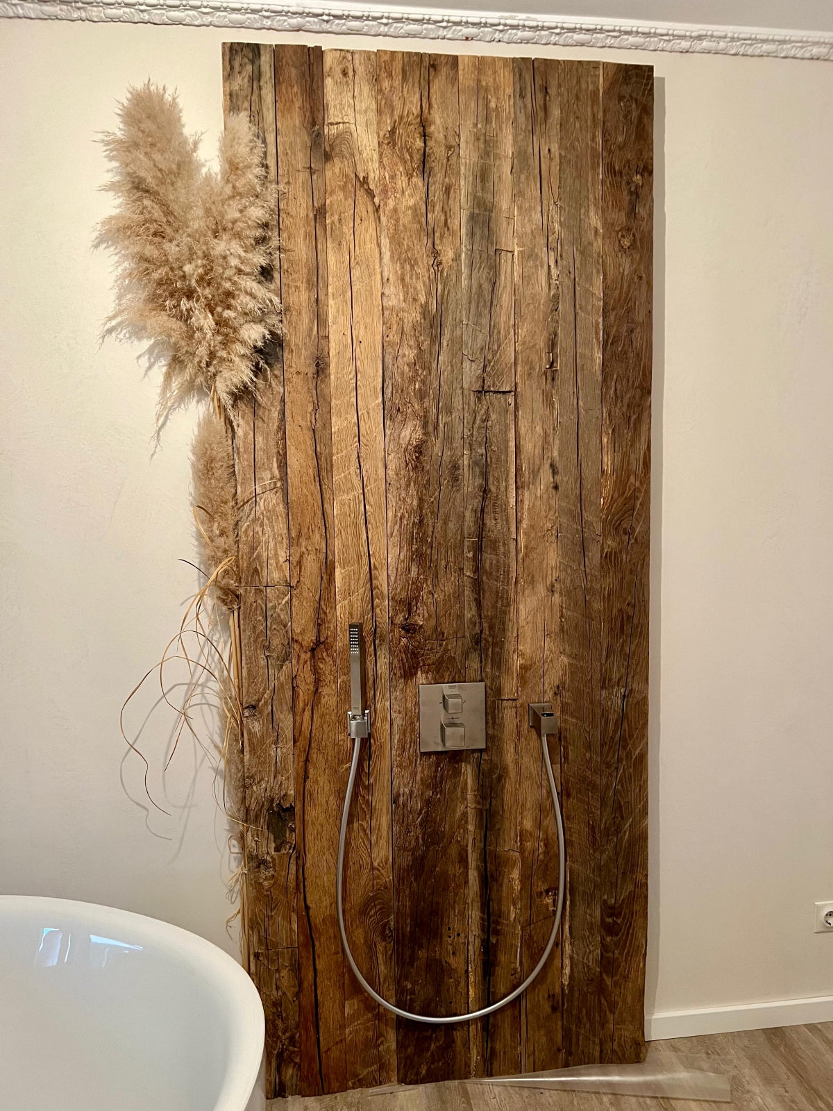 Interior wall finished with hand-hewn reclaimed oak boards