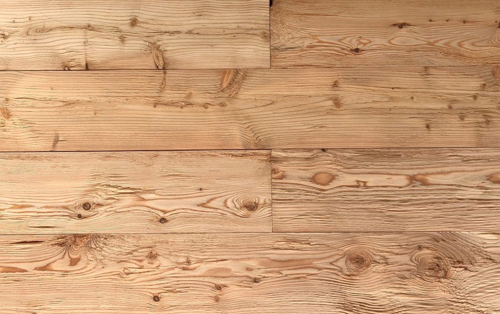 Rustic wall cladding made from hewn and brushed larch boards