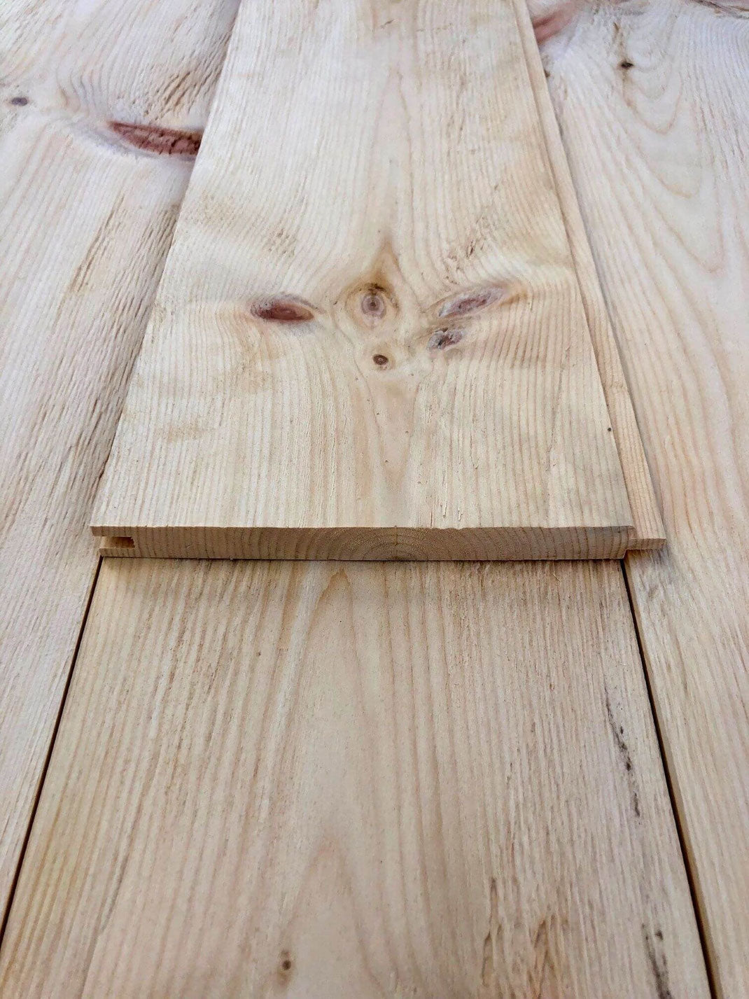 Hewn and brushed Swiss stone pine wall cladding with rustic texture